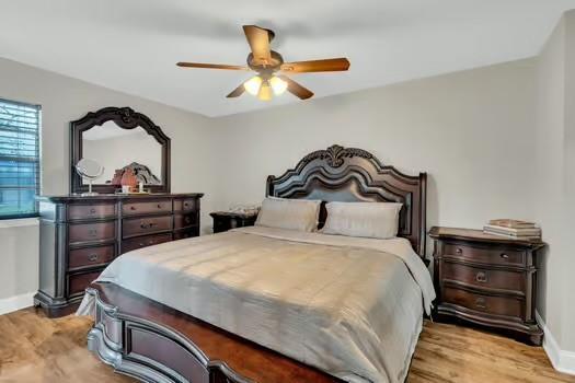 3320 Timberlane Way Dr Unit 134, Harvey, LA 70058 - bedroom with baseboards, ceiling fan, and wood finished floors