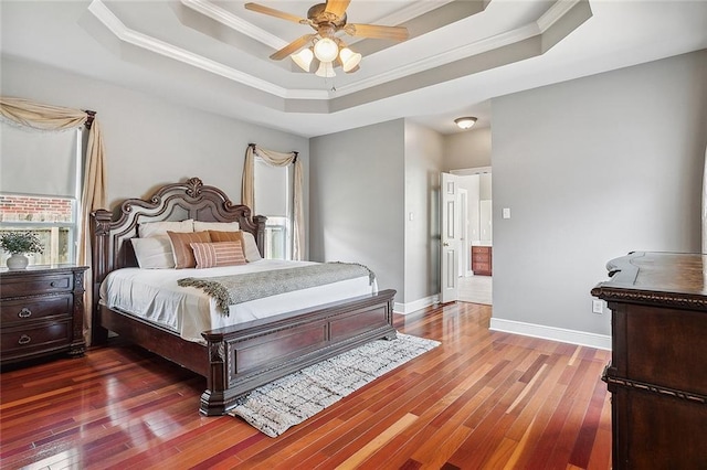 864 Sweet Bay Dr, Mandeville, LA 70448 - bedroom featuring a tray ceiling, ornamental molding, hardwood / wood-style flooring, and baseboards