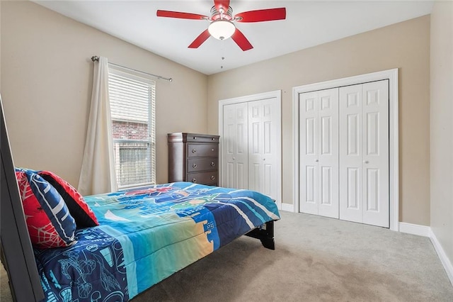 864 Sweet Bay Dr, Mandeville, LA 70448 - bedroom with carpet floors, two closets, baseboards, and a ceiling fan
