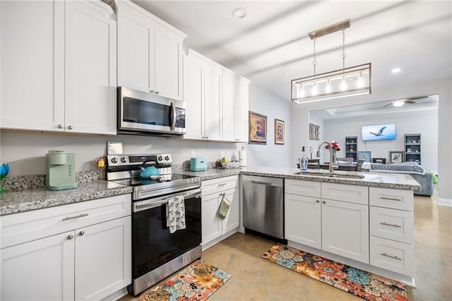 kitchen featuring a peninsula, white cabinets, a sink, concrete floors, and appliances with stainless steel finishes