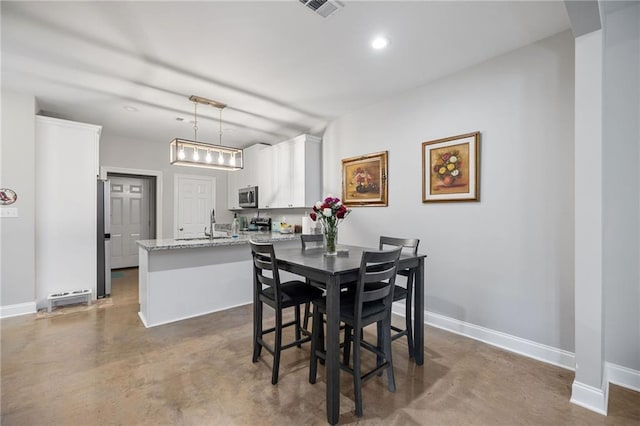 dining area with baseboards, recessed lighting, and concrete floors
