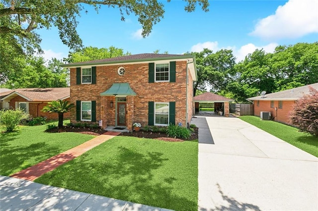 colonial house with fence, a front lawn, central AC unit, a detached carport, and driveway