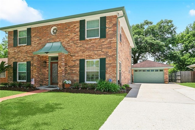 colonial-style house featuring a detached garage, brick siding, fence, and a front lawn