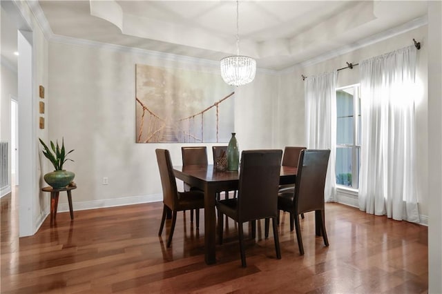 413 Dockside Dr, Slidell, LA 70461 - dining room with an inviting chandelier, ornamental molding, a tray ceiling, and wood finished floors
