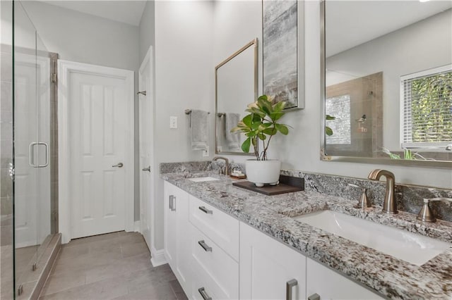 413 Dockside Dr, Slidell, LA 70461 - full bathroom with double vanity, a sink, a stall shower, and tile patterned floors