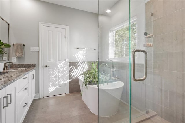 413 Dockside Dr, Slidell, LA 70461 - full bathroom featuring vanity, a soaking tub, a shower stall, and tile walls