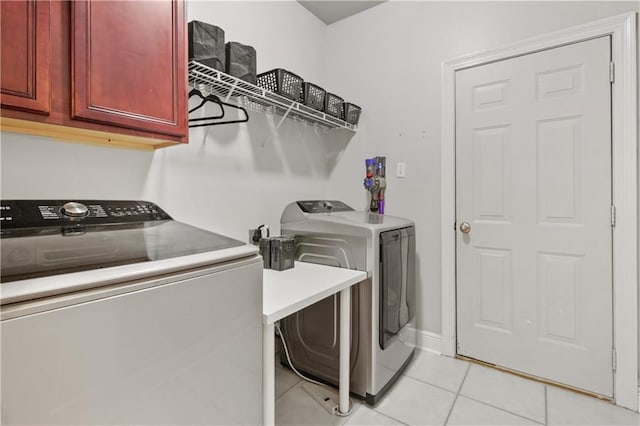 413 Dockside Dr, Slidell, LA 70461 - clothes washing area featuring baseboards, cabinet space, light tile patterned flooring, and washer and dryer