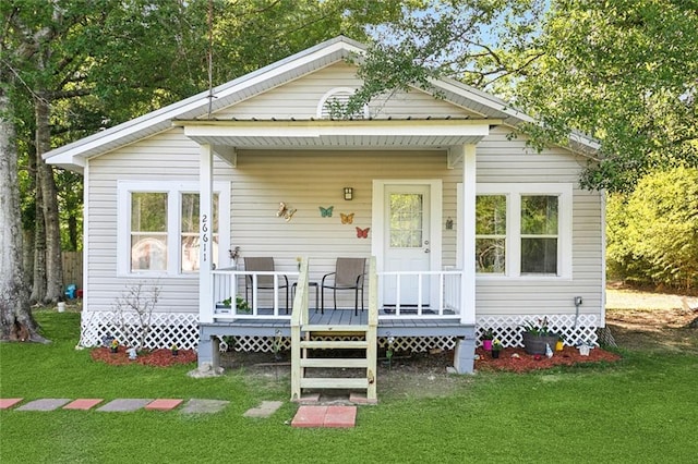 view of front of home with a deck and a front yard
