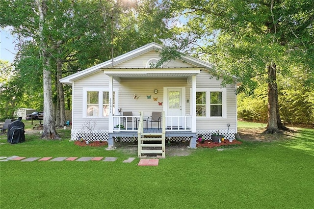view of front of home with a front yard and a deck
