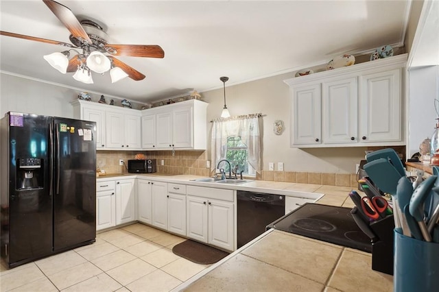 kitchen featuring a sink, white cabinets, light tile patterned floors, and black appliances
