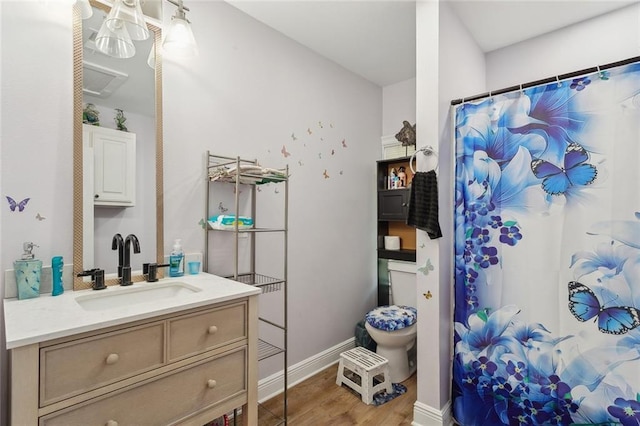 bathroom featuring vanity, baseboards, a shower with curtain, and wood finished floors