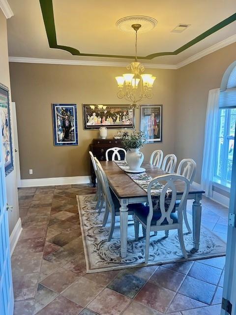 dining space featuring an inviting chandelier, baseboards, crown molding, and visible vents