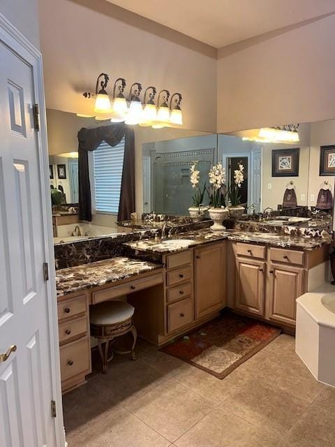 bathroom featuring tile patterned floors, a sink, a garden tub, and a stall shower