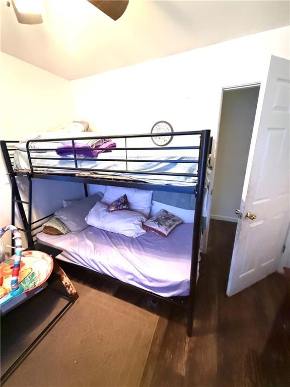 bedroom featuring a ceiling fan and wood finished floors