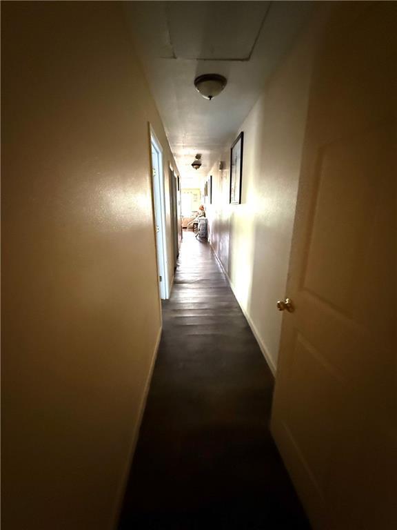 hall featuring baseboards