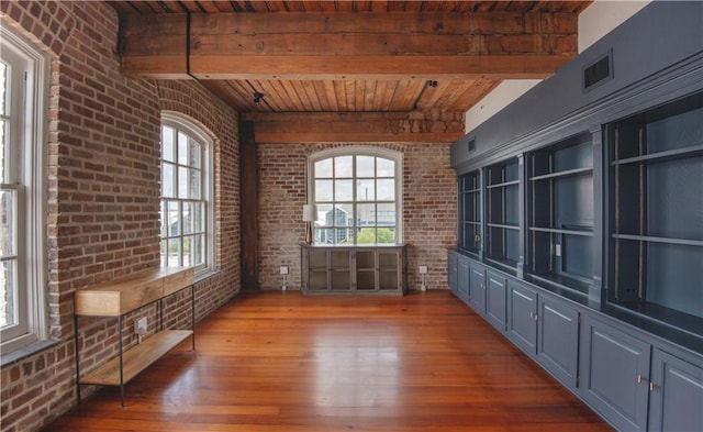 interior space featuring wood-type flooring, beam ceiling, brick wall, and wooden ceiling