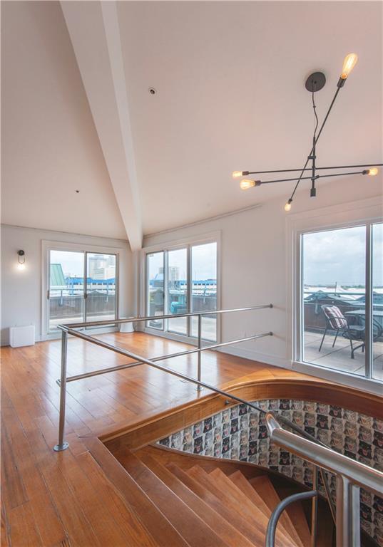dining room featuring baseboards, lofted ceiling with beams, and hardwood / wood-style floors