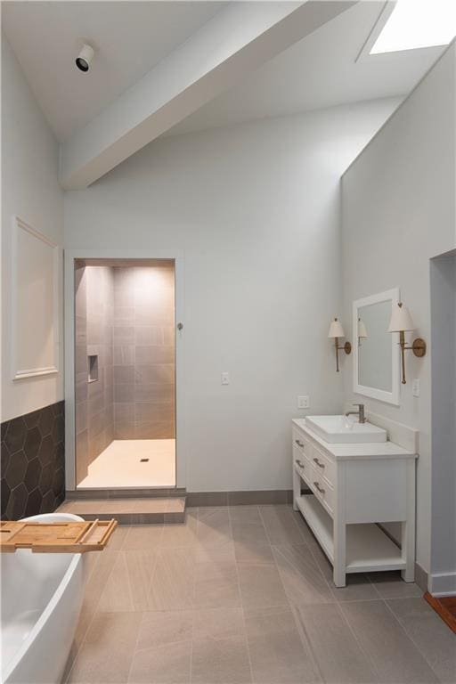 full bath with a freestanding tub, a tile shower, baseboards, and vanity