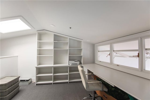 unfurnished office featuring vaulted ceiling and carpet flooring