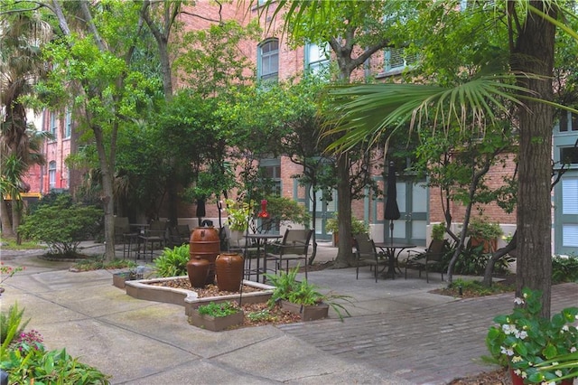 surrounding community featuring a patio and outdoor dining area
