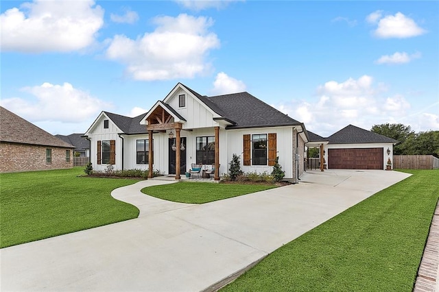 modern farmhouse style home featuring board and batten siding, fence, concrete driveway, and a front yard