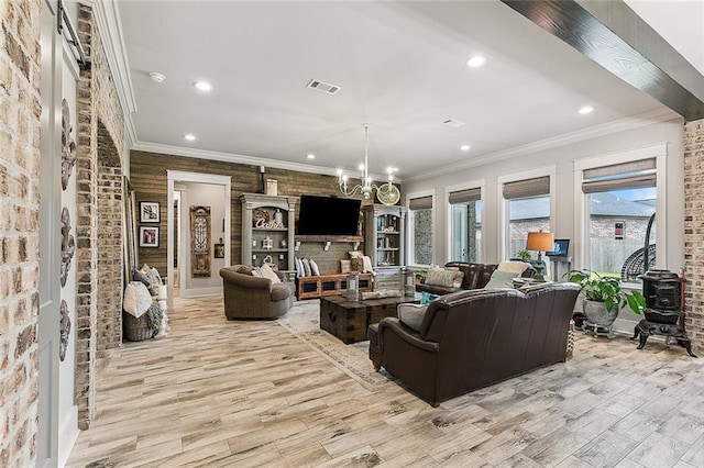living room with crown molding, recessed lighting, and light wood-style flooring