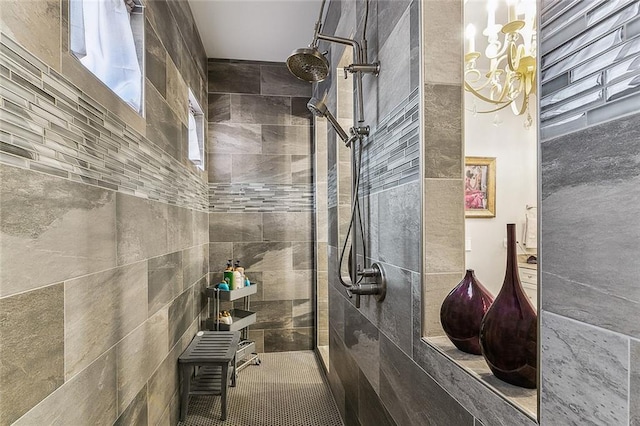 interior space featuring a walk in shower and a notable chandelier