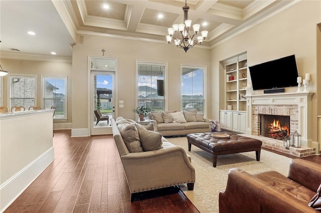living area featuring baseboards, dark wood-type flooring, a notable chandelier, and a wealth of natural light