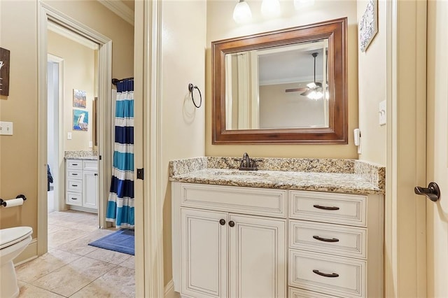 bathroom with crown molding, vanity, ceiling fan, and toilet