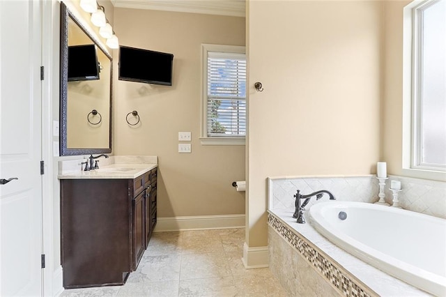 bathroom with baseboards, ornamental molding, a garden tub, and vanity