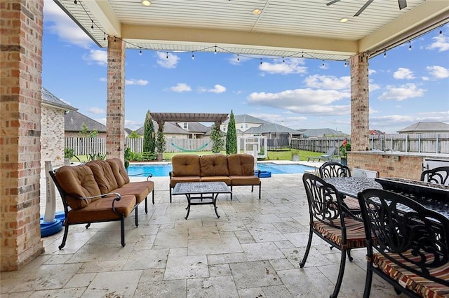 view of patio featuring outdoor dining space, a fenced in pool, an outdoor hangout area, and a fenced backyard
