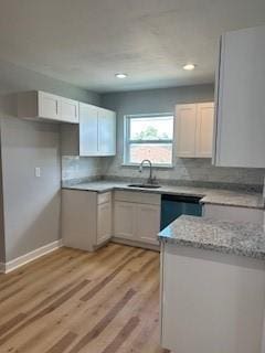 340 Azalea Dr, Waggaman, LA 70094 - kitchen with a sink, light wood finished floors, light stone countertops, dishwashing machine, and recessed lighting