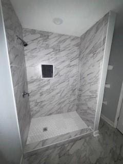 full bath featuring a shower stall, marble finish floor, and visible vents