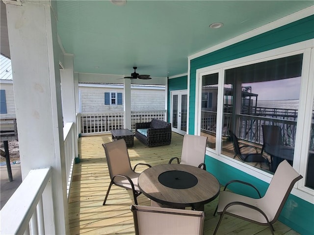 balcony with a ceiling fan and french doors