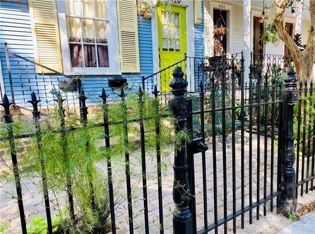 view of gate with a porch and fence