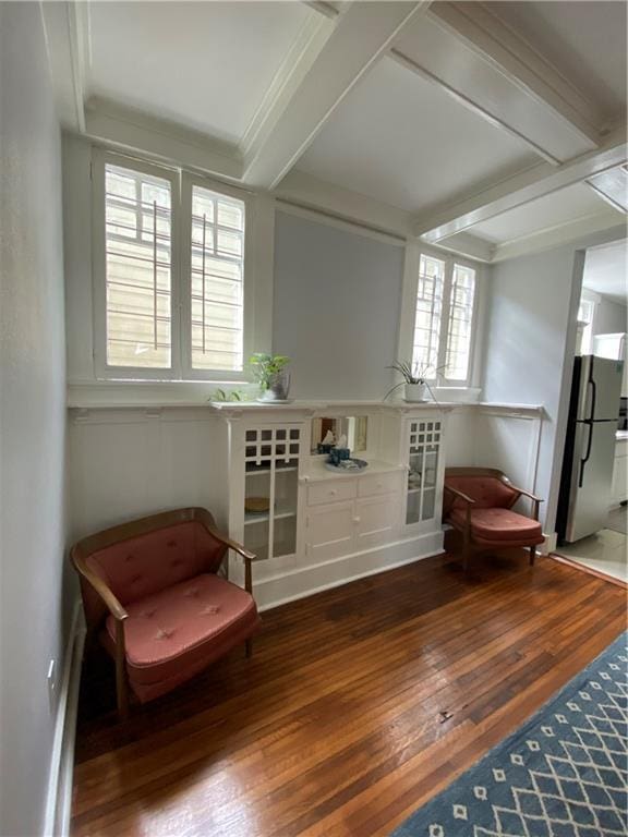 sitting room with wood-type flooring and beamed ceiling