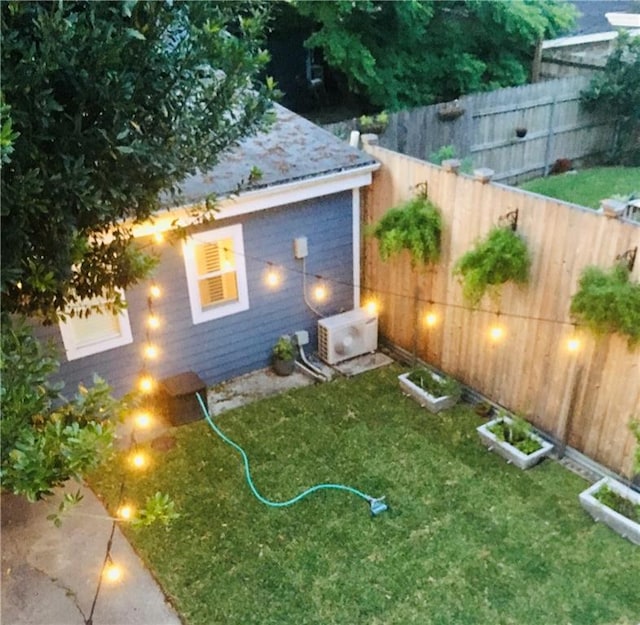 view of yard with ac unit and a fenced backyard