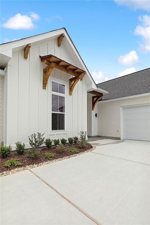 301 Cypress Lakes Dr, Slidell, LA 70458 - exterior space featuring a garage, board and batten siding, and driveway