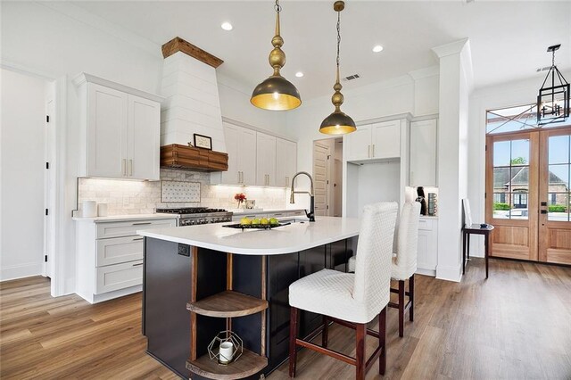 301 Cypress Lakes Dr, Slidell, LA 70458 - kitchen featuring light countertops, tasteful backsplash, white cabinetry, and wood finished floors