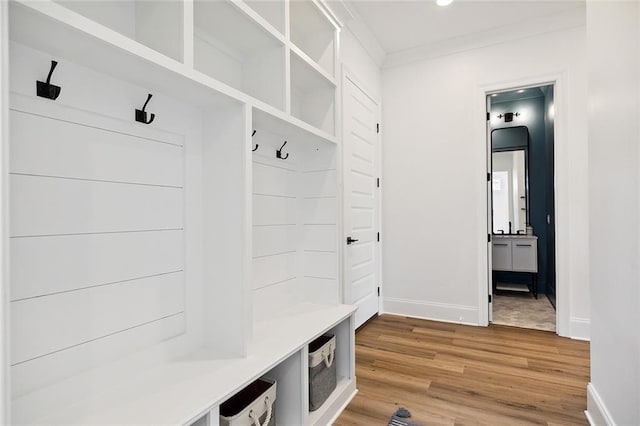 301 Cypress Lakes Dr, Slidell, LA 70458 - mudroom with light wood-style floors, baseboards, and crown molding