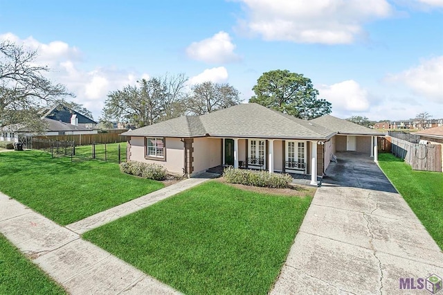 view of front of house with fence, a carport, concrete driveway, and a front yard