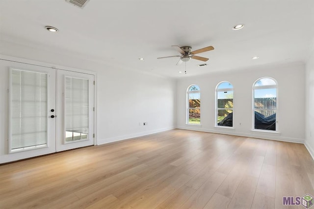interior space featuring baseboards, recessed lighting, french doors, a ceiling fan, and light wood-style flooring