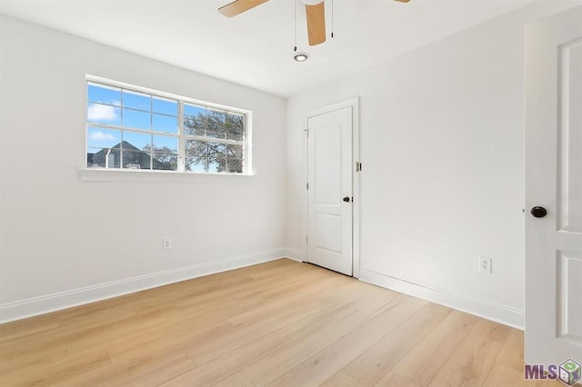 unfurnished bedroom featuring a ceiling fan, baseboards, and light wood-style flooring