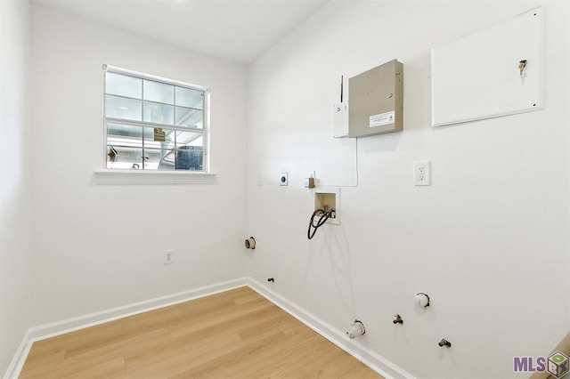 clothes washing area with laundry area, hookup for a gas dryer, baseboards, light wood finished floors, and hookup for a washing machine