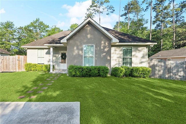 61267 Forest Dr, Lacombe, LA 70445 - rear view of house with stucco siding, fence, and a yard