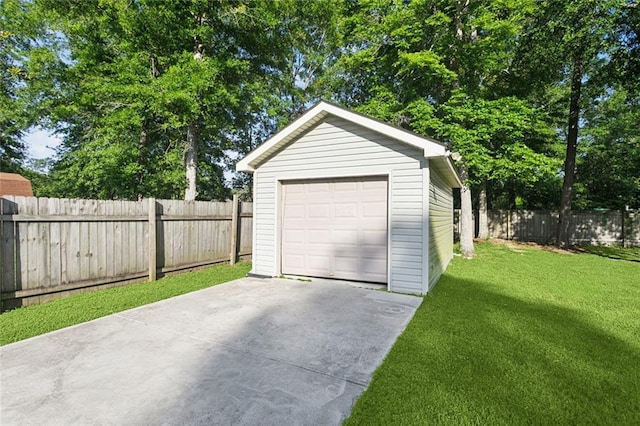 61267 Forest Dr, Lacombe, LA 70445 - detached garage featuring concrete driveway and fence