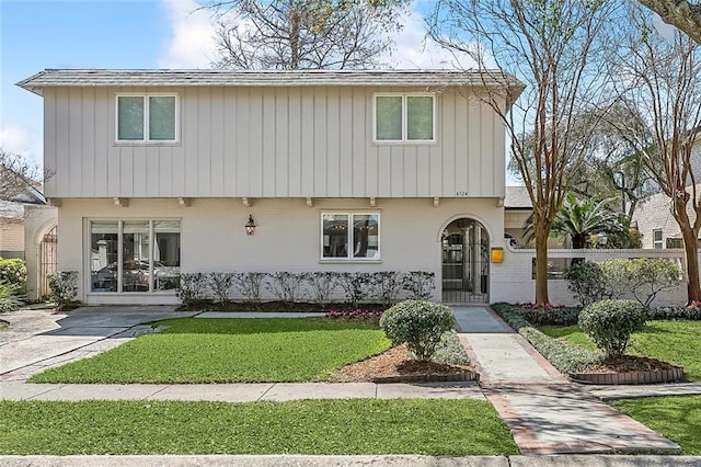 4524 Folse Dr, Metairie, LA 70006 - view of front facade with fence private yard, a front lawn, and brick siding