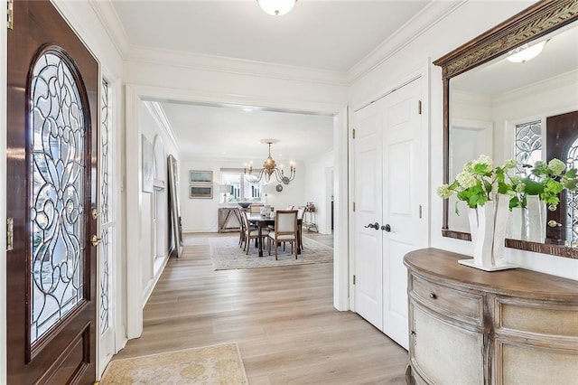 4524 Folse Dr, Metairie, LA 70006 - entryway with an inviting chandelier, light wood-style floors, and crown molding