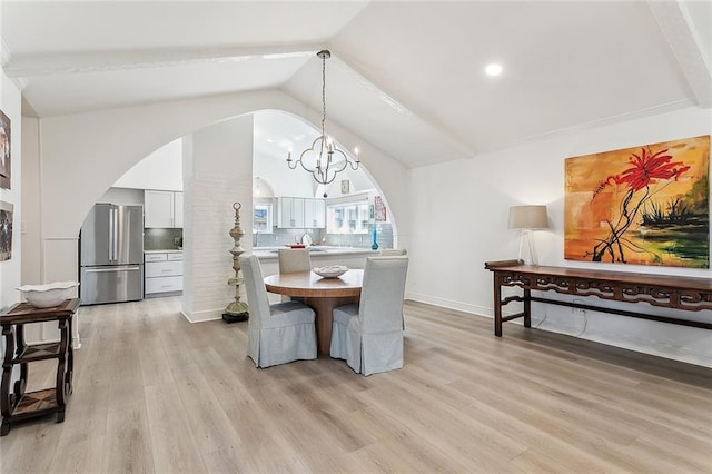 4524 Folse Dr, Metairie, LA 70006 - dining space with arched walkways, vaulted ceiling, an inviting chandelier, recessed lighting, and light wood-style flooring