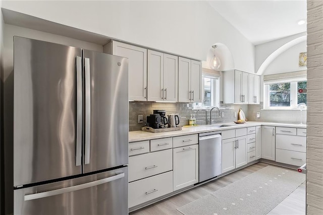 4524 Folse Dr, Metairie, LA 70006 - kitchen featuring light countertops, tasteful backsplash, a sink, light wood finished floors, and stainless steel appliances